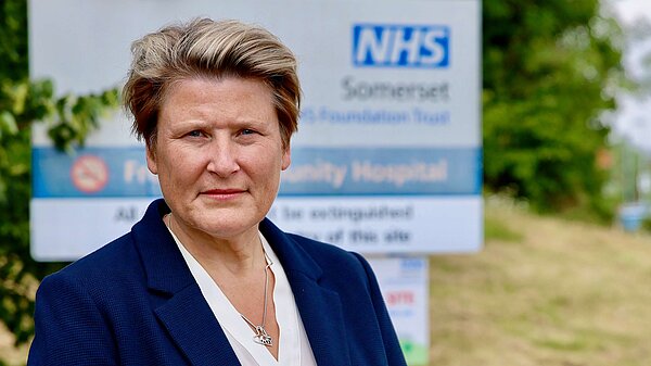Sarah Dyke in front of an NHS sign