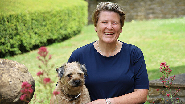 Sarah Dyke with one of her dogs in a garden