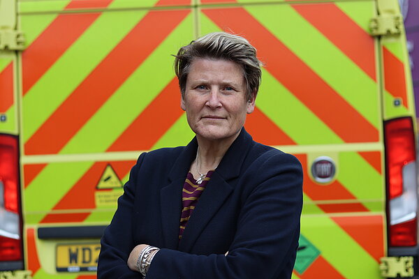 Sarah Dyke MP with an ambulance in the background.