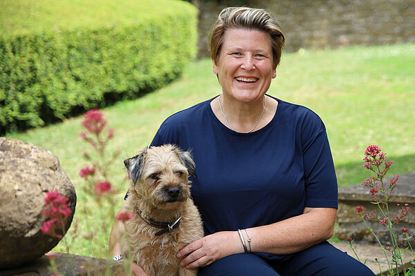 Sarah Dyke with one of her dogs in a garden