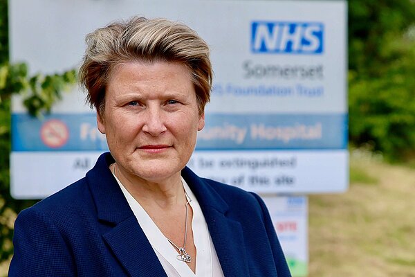 Sarah Dyke in front of an NHS sign