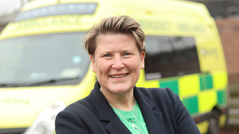 Sarah in front of an ambulance